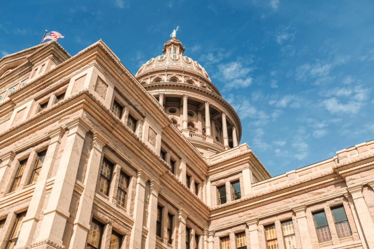 Low angle shot of Texas Capitol building under a blue beautiful sky. Austin city, Texas