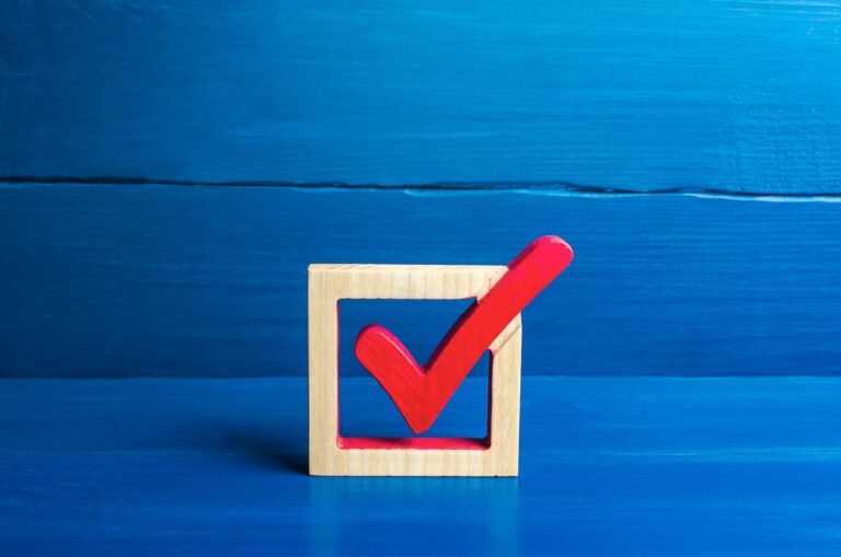 Red voting check mark on a blue background. Voting concept for democratic elections