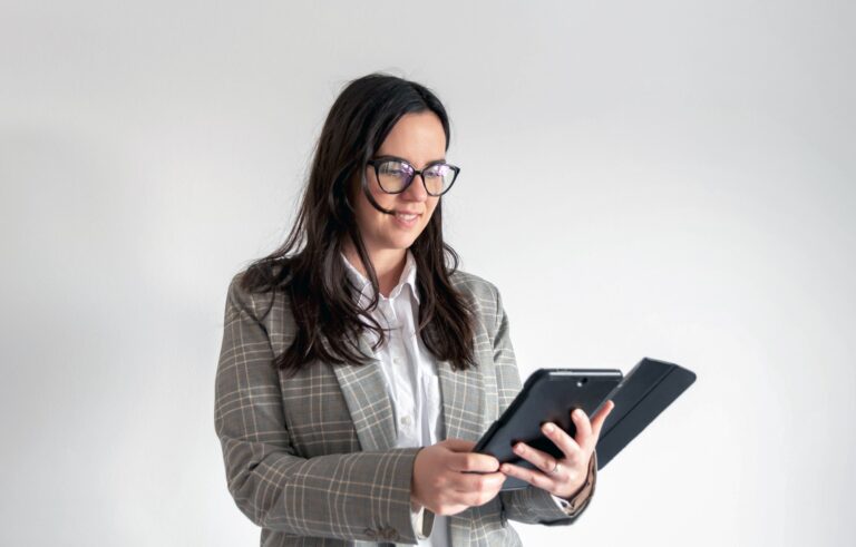 Portrait of a young business woman, business professional holding tablet computer.